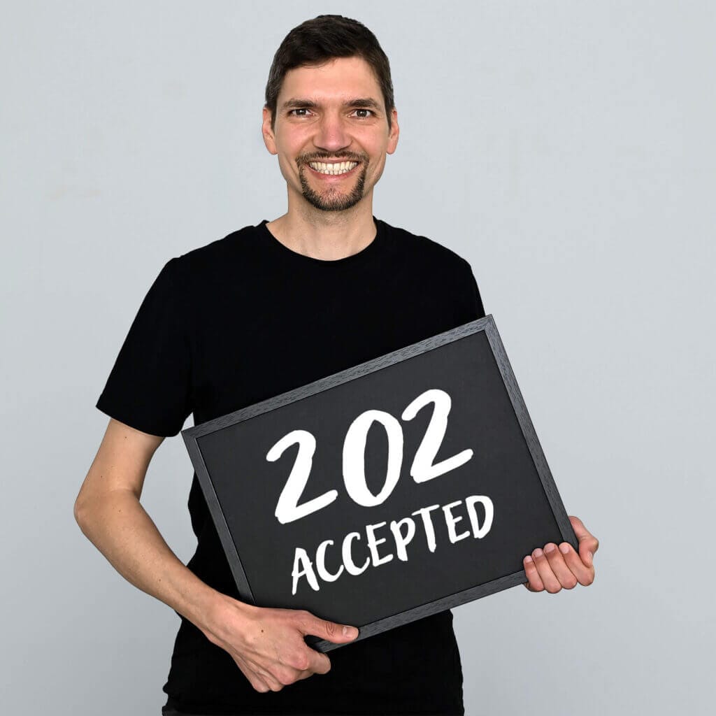Florian Farnung hält ein Schild mit der Aufschrift: 202 accepted